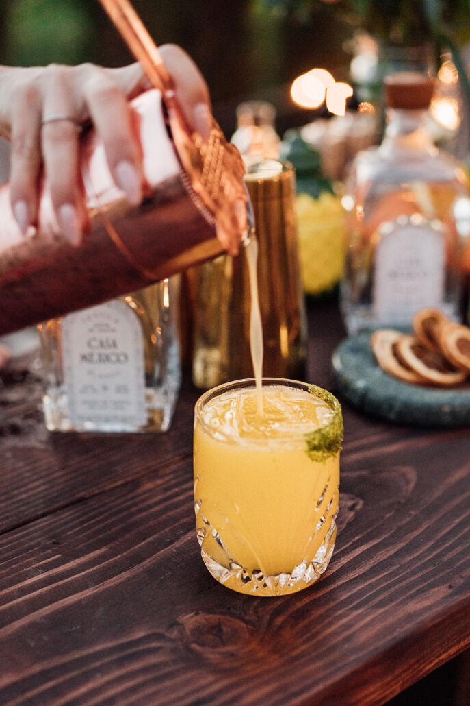 Mixologist pouring a Luz de Verano out of a cocktail shaker